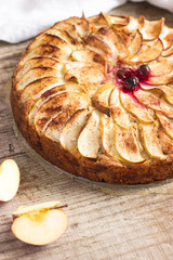 Homemade apple pie on wooden table in rustic style