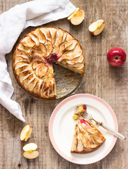 Homemade apple pie on wooden table in rustic style