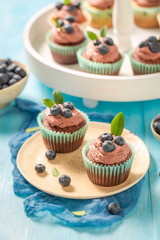Tasty muffin made of chocolate cream and berries