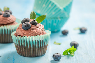 Closeup of cupcake with blueberries and chocolate cream
