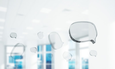 Concept of communication by glass empty chat icon on office background. Mixed media