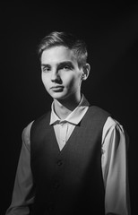 Portrait of a beautiful teenager in strict clothes with authentic appearance in vintage style