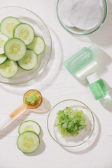 Cosmetic bottle and fresh organic cucumber for skincare. Home spa concept.