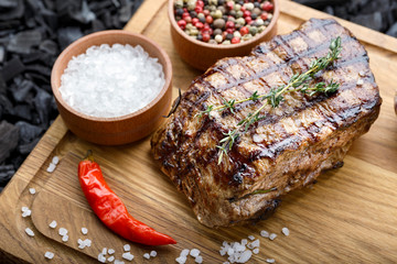 grilled steak on wooden background