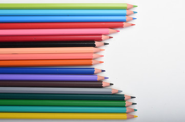 colored pencils on a white background