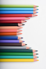 colored pencils on a white background