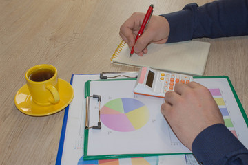 Man hand with calculator at workplace office. Business and accounting concept