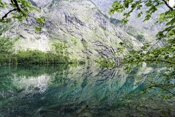 Mirror reflection  in green Obersee lake. 
