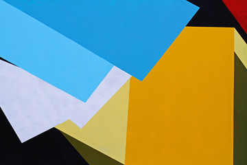 Colorful (blue, white, yellow, green, red and black) painted wall as background or texture