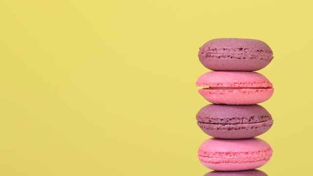 Stack of macaroons rotating on yellow background