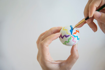 People painting colorful Easter eggs - Easter holiday celebration concept