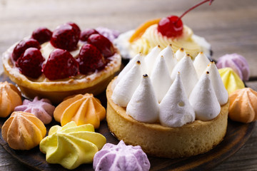 dessert background. delicious assorted cakes. cream cheese cupcake, berry tart, lemon meringue tart. sweet treats and cookies, confectionery