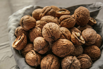 Tasty walnuts on grey background, closeup