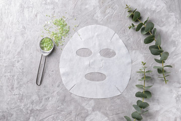 Sheet facial mask with sea salt on grey background