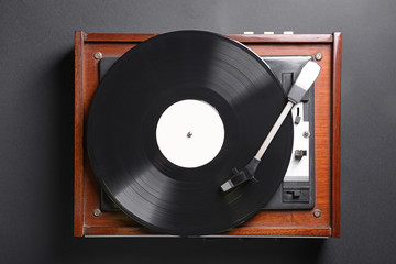 Record player with vinyl disc on dark background - Powered by Adobe