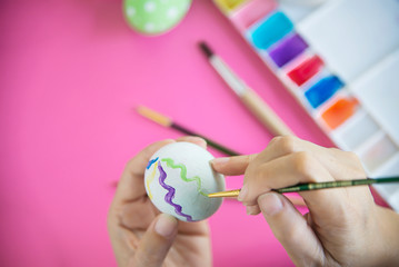People painting colorful Easter eggs - Easter holiday celebration concept