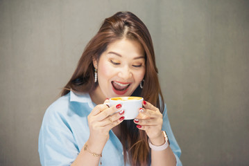 Portrait happy young Asian lady in coffee shop - woman in relax time concept