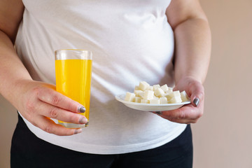 sugar content in fruit juice and sweet carbonated drinks with stack of cubic sugar. diabetes and...