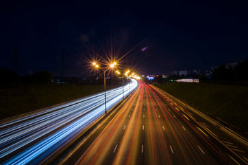 Fototapeta na wymiar night highway. oiled lights of the night city. long exposure of car lights. night traffic