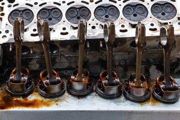 Part of the engine removed from a used car for repairing silver metal and aluminum with six pistons...