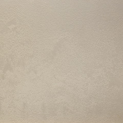 Photo of old gray cement wall with fractures.