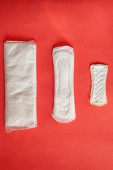 Feminine hygiene pads on red background