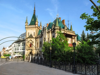 Fototapeta premium Slovakia, Kosice - May 2, 2018: Jakab's Palace (Jakabov palac) in Kosice - view from the bridge. Beautiful fairy palace with a green roof in a spring sunny day