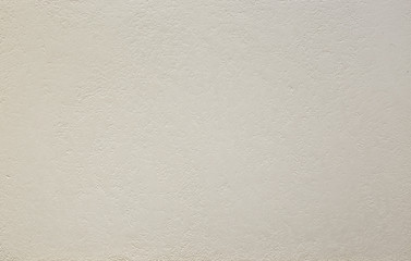 Photo of old gray cement wall with fractures.