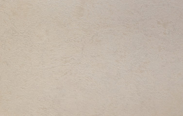 Photo of old gray cement wall with fractures.