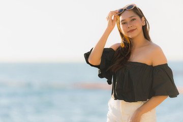 Portrait beautiful young asian woman happy and smile on the beach sea and ocean