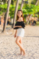 Portrait beautiful young asian woman happy and smile on the beach sea and ocean