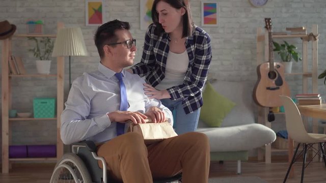 Young woman gathered lunch for her disabled husband in a wheelchair