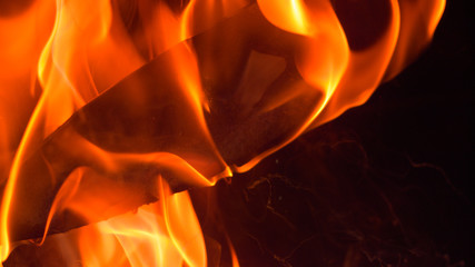 MACRO DOF: Cinematic shot of a flaming blade being lifted out of the hot oil. - obrazy, fototapety, plakaty