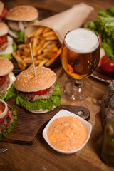 Close up of beef burger and beer on a restaurant table