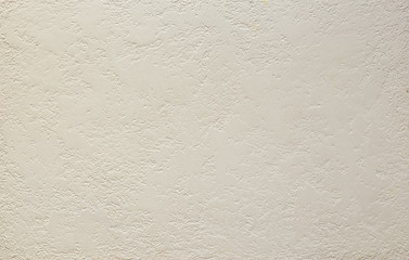 Photo of old gray cement wall with fractures.