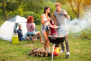 Male and female smell and taste grilled barbecue