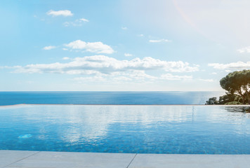 Plakat Luxury swimming pool in front of the sea. Swimming pool with beautiful sea and sky view.