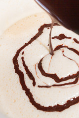 Cooled melted dark chocolate poured in the beaten eggs with sugar