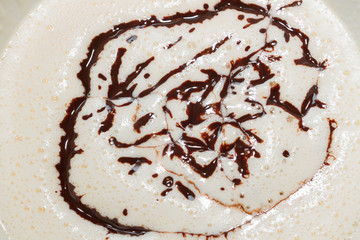 Cooled melted dark chocolate poured into the beaten eggs with the sugar