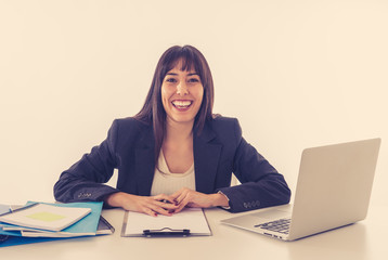 Portrait of a young beautiful business woman happy and confident working on computer at office