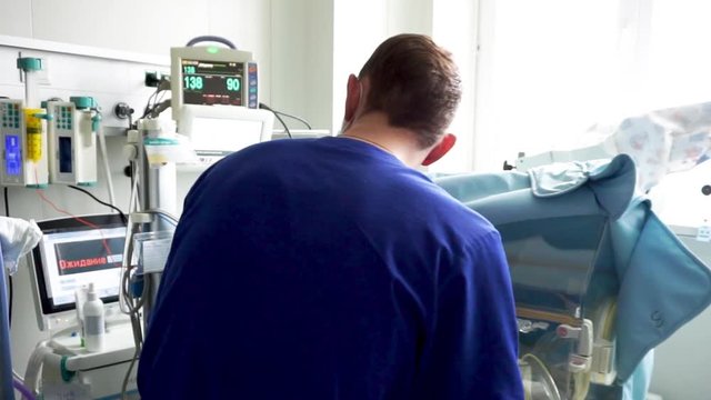 A doctor in the intensive care unit. Resuscitator equipment. Neonatal incubator
