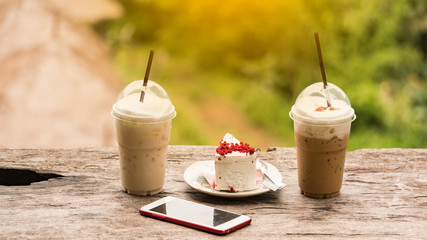 On the table with coffee and cake and telephone