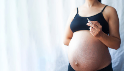 pregnant woman smoking cigarette