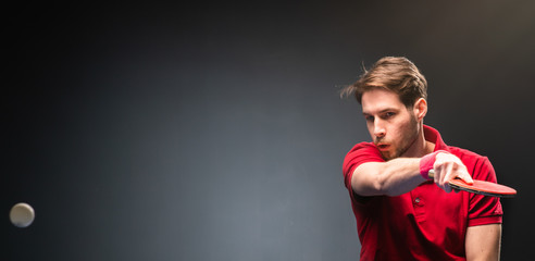 Handsome young man playing ping pong table tennis