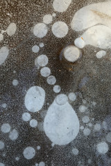 Frozen ice with a lot of ice bubbles and cracks