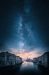 Artistic view of grand canal and Basilica di Santa Maria della Salute in Venice, Italy under majestic milky way © Jamo Images
