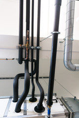 metal and plastic pipe system on the cellar ceiling of an apartment building