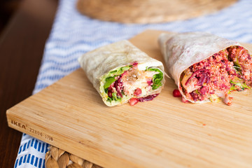 Organic Healthy Wraps with salad, quinoa, grilled chicken, red cabbage, celery and pomegranade, humus, coleslaw, beet, cheese and caramelised onions. Two different kind of shawarma.