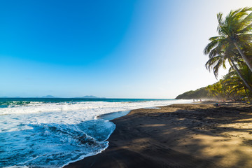 Dark shore in Grande Anse beach in Guadeloupe