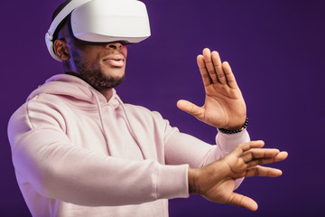 African professional boxer looking through the competition with his participation, using VR glasses, studying mistakes and tactic of opponent